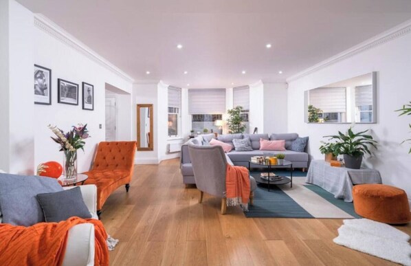 Immerse yourself in the warm embrace of orange hues and indulge in regal comfort fit for a royal. You can also enjoy reading a book while relaxing at our living area or watch a series that you like with the smart tv installed.