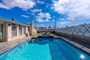 Pool with view of backyard and Spa