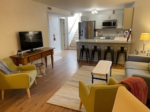 The open concept living room and kitchen is comfortable and inviting.