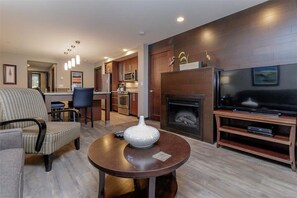 Spacious living room with electric fireplace.