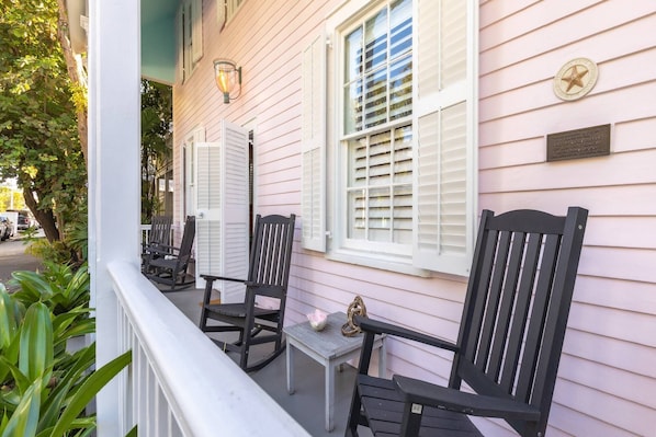 Take a moment to unwind and savor your favorite beverage while gently rocking on the front porch, a truly idyllic setting for relaxation.