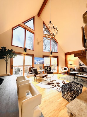 Stunning A-Frame great room with 24-ft wall of windows & panoramic lake views!