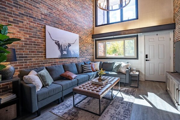 Beautiful, 2 story living room. Equipped with 65” smart TV, wood burning fireplace, dry bar with mini-fridge, ski and bike storage (inside), full spa-like bathroom, sitting area & couch fitting up to 6 comfortably.