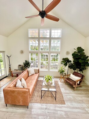Beautiful living room filled with natural light, gas fireplace, TV, and more!