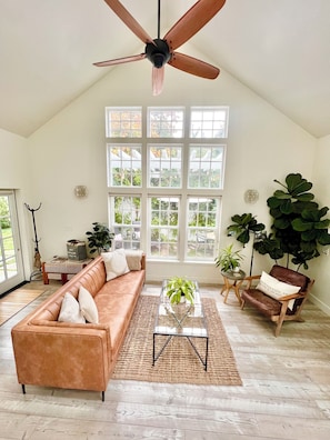 Beautiful living room filled with natural light, gas fireplace, TV, and more!