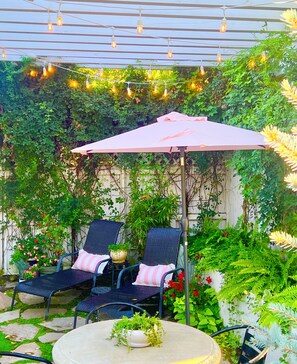 Beautiful backyard private garden with table for 4 and a barbecue and more