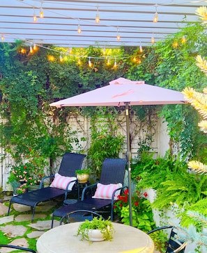 Beautiful backyard private garden with table for 4 and a barbecue and more