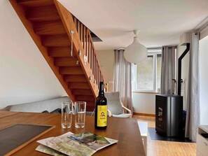 The open plan living room kitchen has patio doors to a balcony