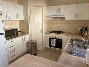 Kitchen with Fridge, Dishwasher, Microwave, Kettle, Toaster, Stove and Oven