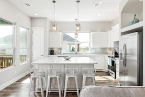 Sit up at the breakfast bar and keep the chef company
