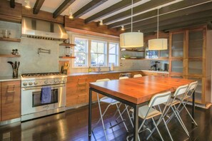 This beautiful, chef's kitchen features Thermador appliances and custom cabinetry.