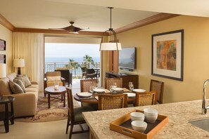 Living room opens to a large lanai with tropical furnishings.