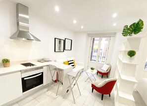 Close-up of kitchen - worktop with stools and living area
