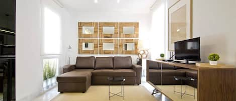 View of the living room, with sofa, television and design decoration.