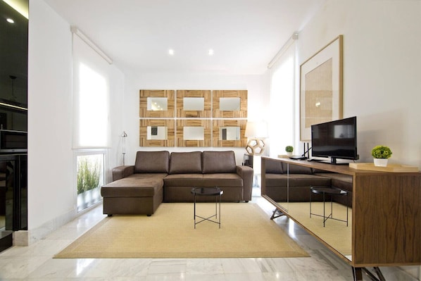 View of the living room, with sofa, television and design decoration.