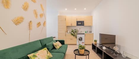 General view of the living room with the kitchen in the background