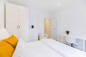 View of one of the bedrooms with a double bed, wardrobe and desk