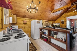 Discover the charm of our compact kitchen in the cozy cabin. With everything at arm's reach, this little space packs a punch for all your culinary needs.