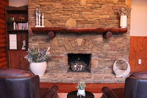Grab a book from the library and enjoy the cozy fireplace in the dining room.