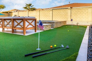 Putting Green | Fun for Golf Enthusiasts of All Ages Practice your short game on the backyard putting green, complete with flags and plenty of space to perfect your swing.