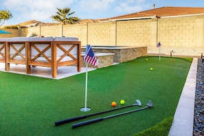 Putting Green | Fun for Golf Enthusiasts of All Ages Practice your short game on the backyard putting green, complete with flags and plenty of space to perfect your swing.
