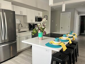 Bright Kitchen with an island for socializing with the cook.