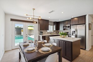Open concept kitchen and dining area.  The french doors open out to the pool.