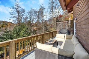 Large Deck Couch and Gas Fire Table Overlooking Custom Stone Outdoor Space