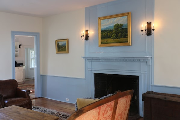 Sitting room with high ceilings, a cozy fireplace and comfy furnishings