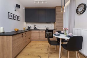 A stylish kitchen and dining area with wooden cabinetry and a contemporary design.
