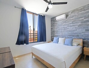 Bedrooom 1 w/ plush king bed, AC, ceiling fan & good closet space