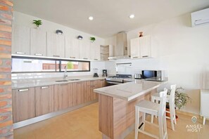 A breakfast bar at the kitchen counter