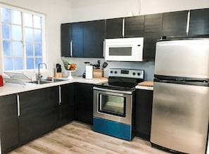 Full Kitchen includes all pots, pans, silverware, coffee maker, coffee, sugar, creamer, tea, blender, toaster, refrigerator, microwave, glasses, wine glasses and cooking/eating utensils
