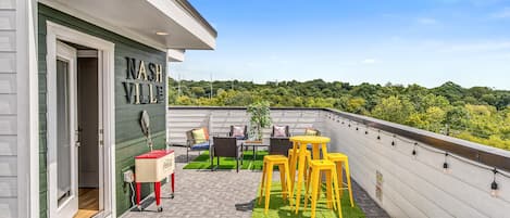 Our sprawling rooftop lounge offers ample patio seating and bar seating, corn hole boards, and stellar views.