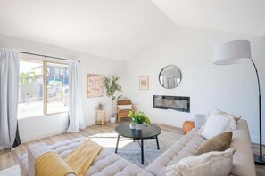 Light the electric log fire on a chilly evening to create a cozy, inviting space