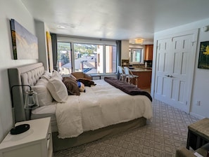 King bed with view of kitchen