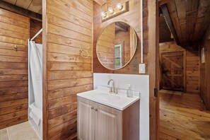 Newly renovated, full bathroom with shower/tub combo.