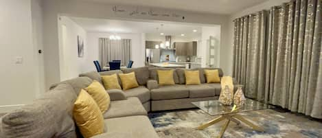 Living room with sectional and coffee table, smart tv