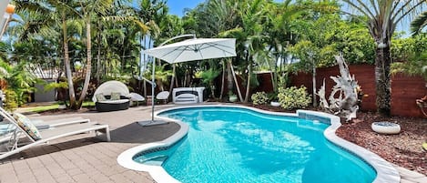 Relax in the private backyard with amazing views day & night and amenities that include a heated pool, 6 person hot tub, comfortable sun loungers and daybed, large umbrella for shade, BBQ grill and al fresco dining in the lanai, all surrounded by lush tropical landscaping.