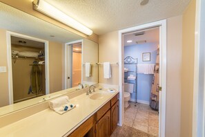 En-suite master bath with single vanity and walk-in shower
