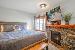 Enjoy the fireplace and TV from your king size bed