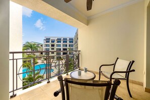 Have a cup of tea while you enjoy the pool and garden view from your balcony.