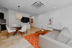 Chic and modern living room with an open view to a dining area.