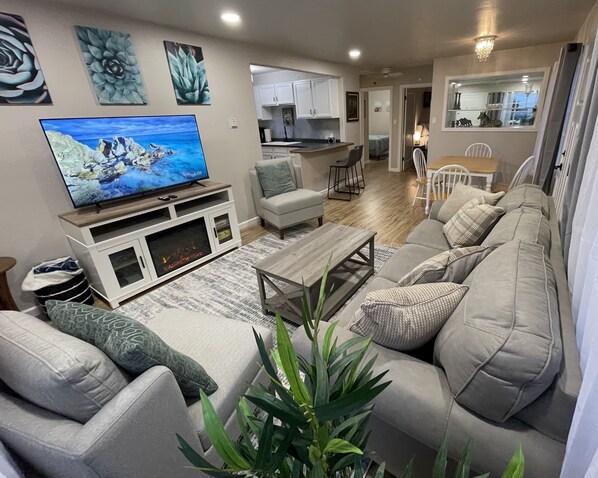 All new furniture in living room with big smart tv and pull-out sofa.