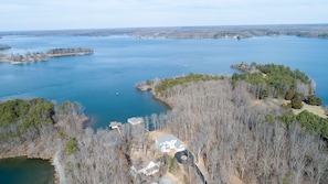 Aerial view of property and open water with private secluded quiet cove.