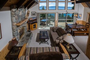 The view over the open living room and dining area complete with soaring windows providing stunning views over Lake Tahoe.