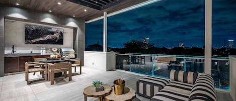 Rooftop Terrace: lounge area, dining table, and 82”tv … and downtown views