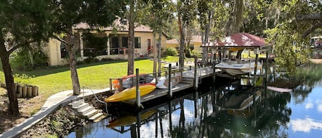 view of dock, kayaks, boat on lift
