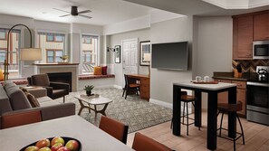 View from dining room into living room with part of kitchen visible