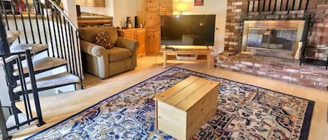 spacious living room with wood burning fireplace